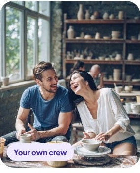 Two people chatting over coffee at a cafe window